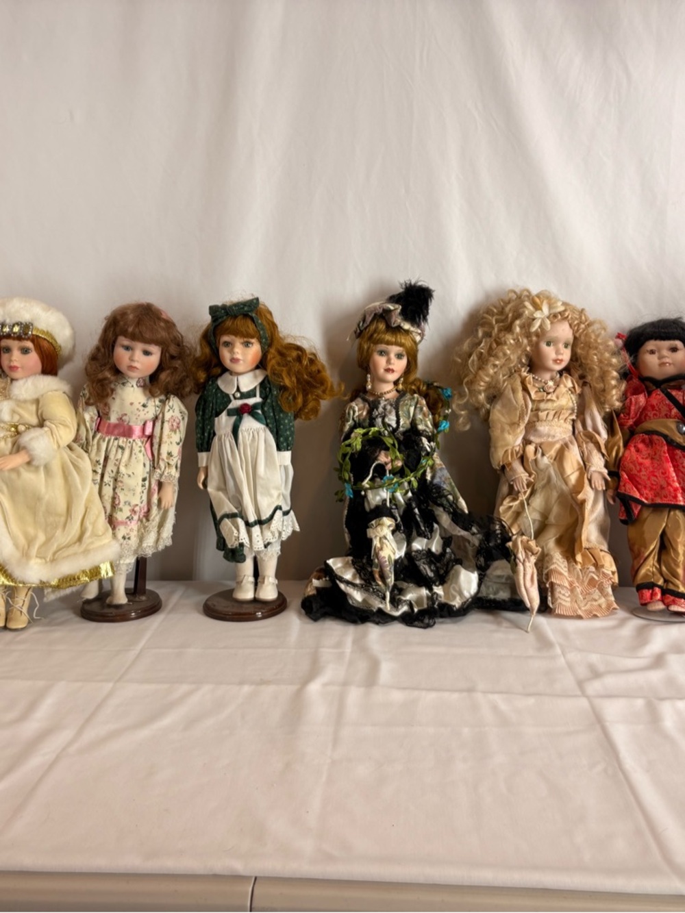 Imperial Porcelain Collector Doll Group with Black, Cream, Green and Red Accents